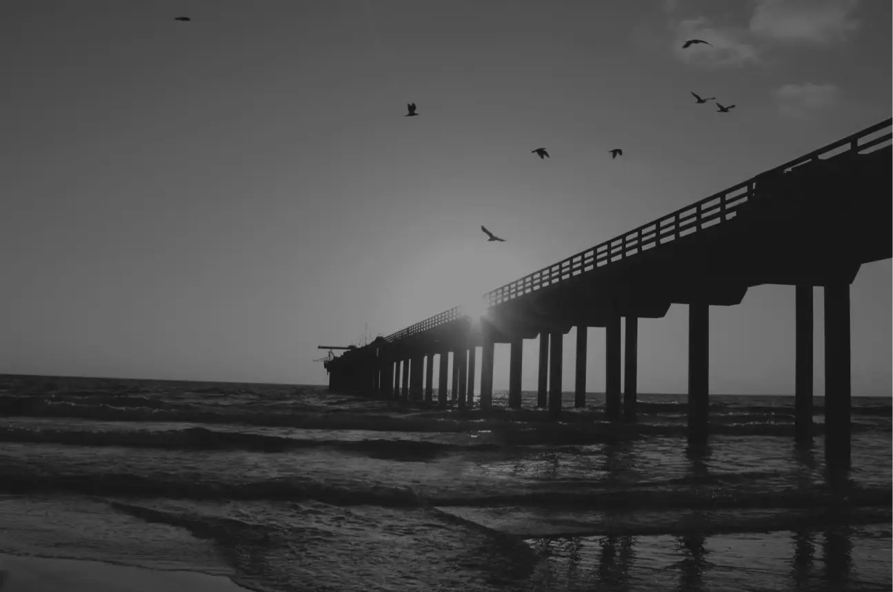 Photo of pier extending out into the ocean